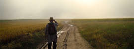 Man walking down a dirt road