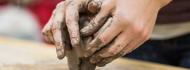 Hands sculpting clay